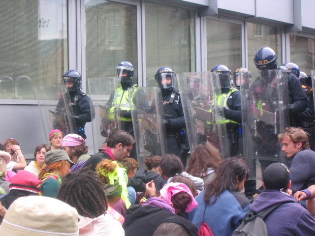Sitting in front of riot police