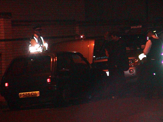 Police inspect car at convergence space Tuesday night