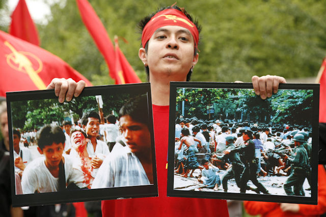 A Burmese activist shows photos from 8-8-88