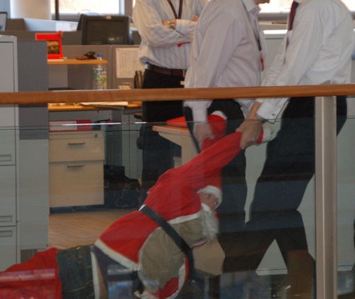 Suits drag santa in office bail out shocker