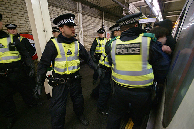 A man is shoved onto a train, he is later marched out at Victoria.