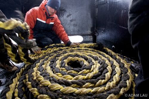 Crew member coils an prop fouler (used to disable ship's propellers)