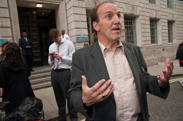 Simon Hughes reacts to a video journalist