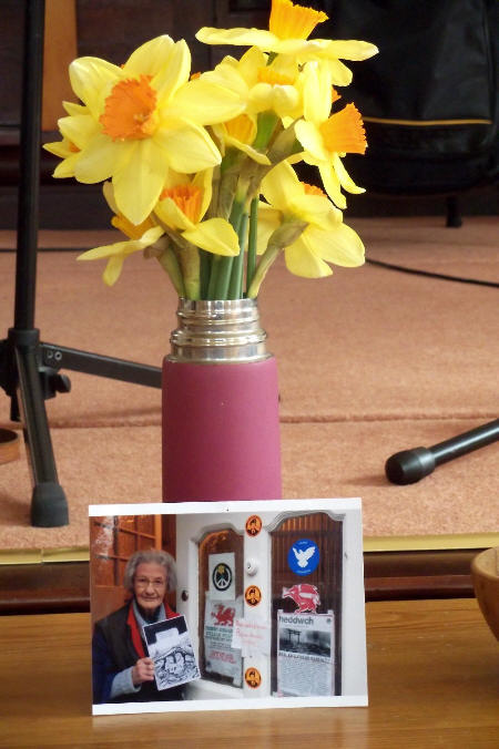 Flowers for Lib (photo of her at front door complete with Free Manning stickers)